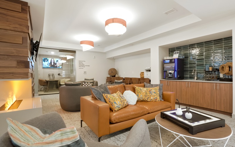 a room with a couch and chairs